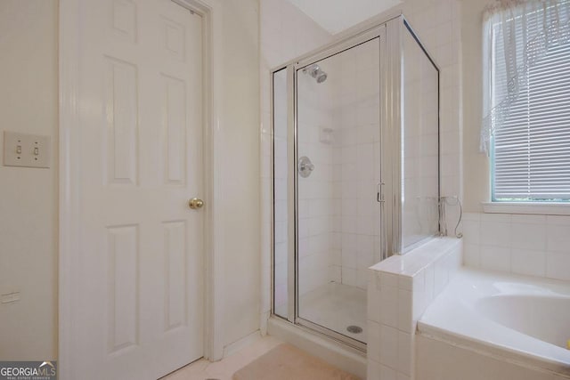 bathroom featuring independent shower and bath