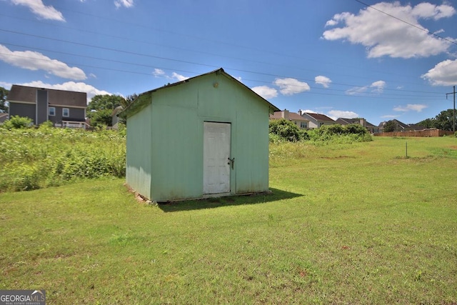 view of outbuilding featuring a yard