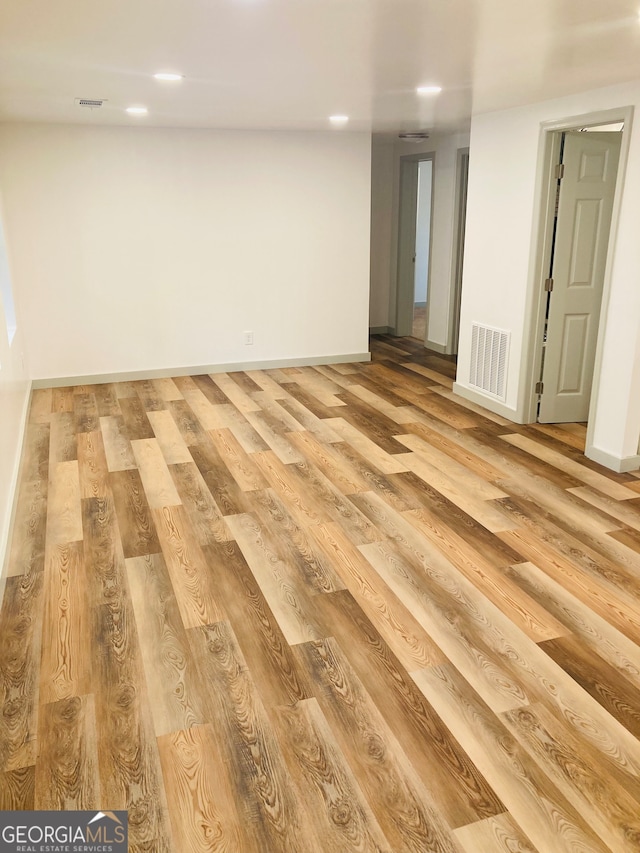 empty room with light hardwood / wood-style flooring