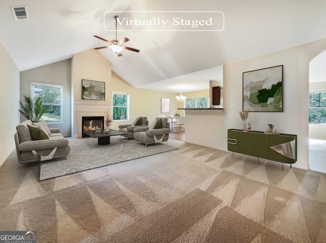 living room featuring vaulted ceiling, plenty of natural light, carpet, and ceiling fan