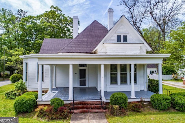 315 Dixie St, Carrollton, GA 30117 - view of front of property featuring a shingled roof, covered porch, and a chimney