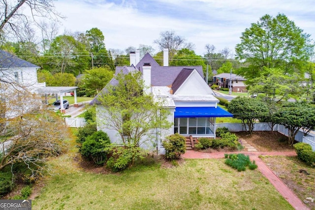 315 Dixie St, Carrollton, GA 30117 - rear view of property with a chimney, fence, and a lawn