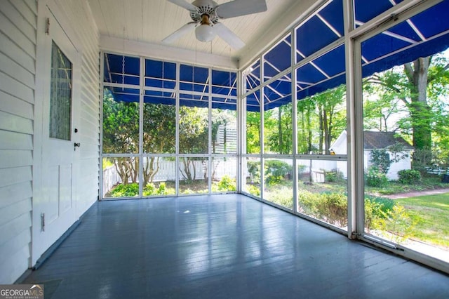 unfurnished sunroom with ceiling fan