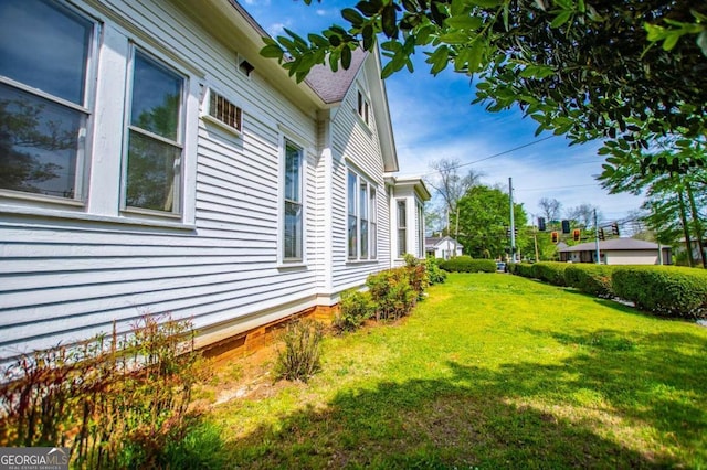 view of side of home featuring a lawn