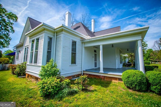 rear view of property with a yard