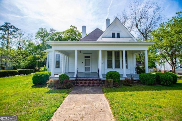 315 Dixie St, Carrollton, GA 30117 - view of front of home featuring a front yard, a chimney, and covered porch