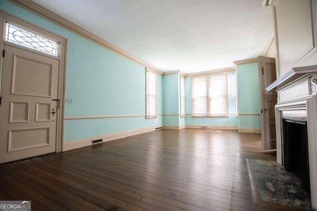 unfurnished living room with a premium fireplace, dark hardwood / wood-style floors, and ornamental molding