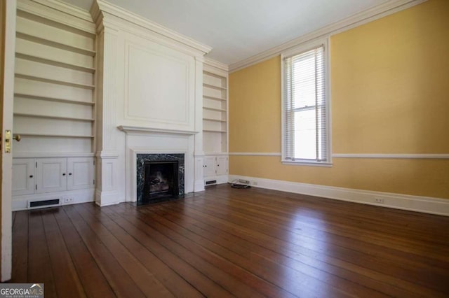 unfurnished living room featuring built in features, a fireplace, dark hardwood / wood-style flooring, and ornamental molding