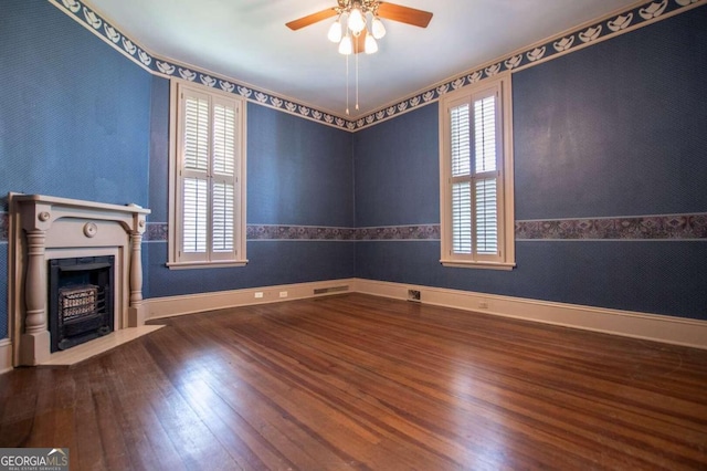 315 Dixie St, Carrollton, GA 30117 - unfurnished living room featuring a fireplace with flush hearth, wood-type flooring, a ceiling fan, and plenty of natural light