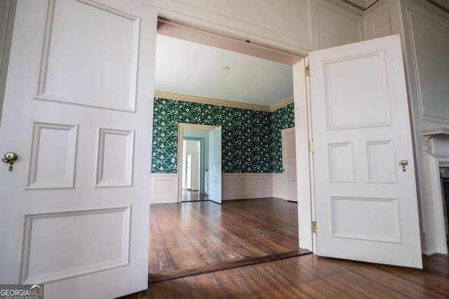 315 Dixie St, Carrollton, GA 30117 - hallway with a decorative wall, wainscoting, hardwood / wood-style floors, and crown molding