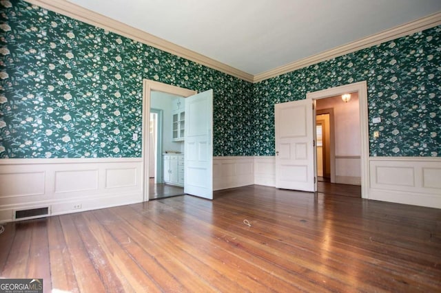 315 Dixie St, Carrollton, GA 30117 - unfurnished room featuring a wainscoted wall, visible vents, wallpapered walls, and crown molding
