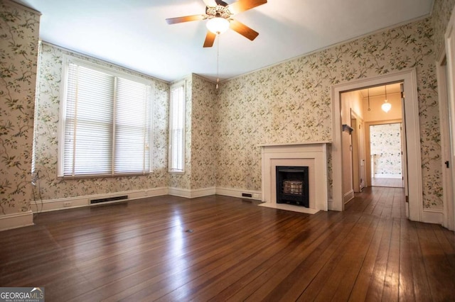 unfurnished living room with dark wood-type flooring, a wealth of natural light, and ceiling fan