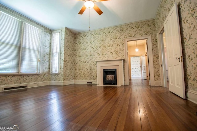 unfurnished living room with ceiling fan and hardwood / wood-style floors