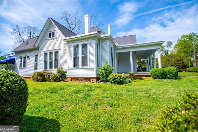 315 Dixie St, Carrollton, GA 30117 - back of house featuring a yard, covered porch, and a chimney