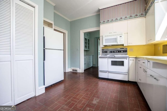 315 Dixie St, Carrollton, GA 30117 - kitchen with white appliances, light countertops, crown molding, brick patterned floor, and white cabinets