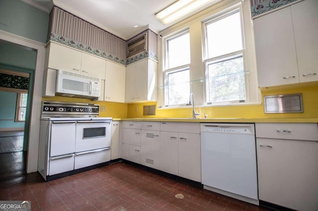 315 Dixie St, Carrollton, GA 30117 - kitchen featuring a wealth of natural light, white appliances, a sink, and brick patterned floor