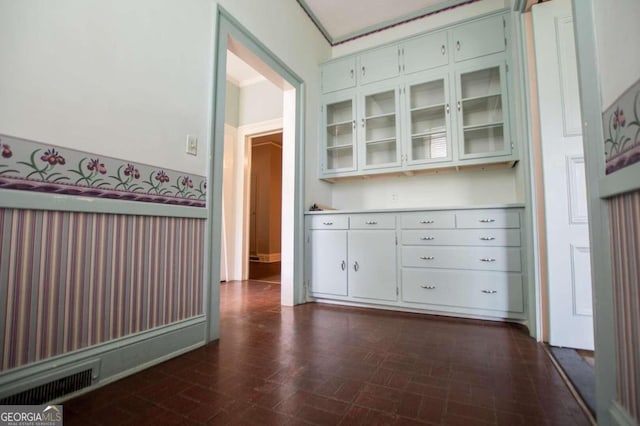 interior space with dark hardwood / wood-style floors and ornamental molding