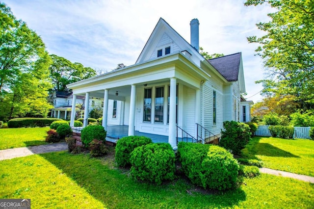 view of front of property with a porch and a front lawn