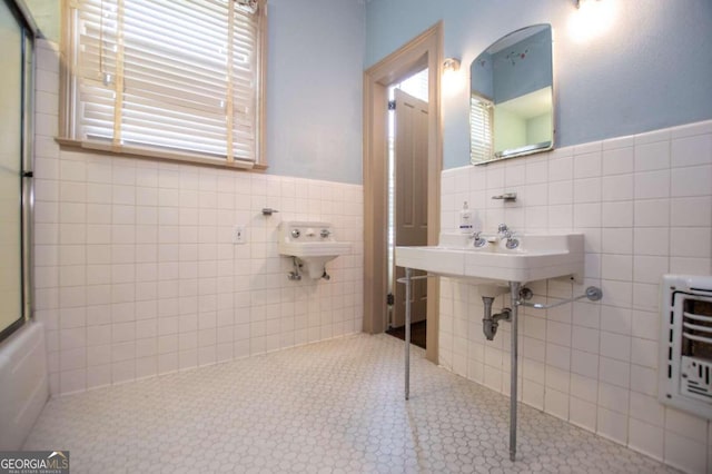 bathroom with tile patterned flooring, tile walls, and backsplash