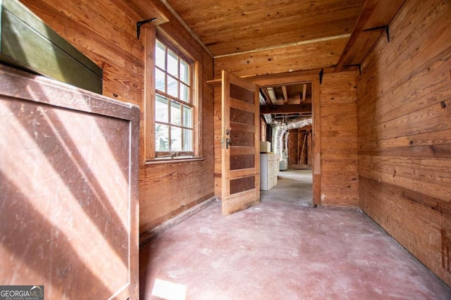 interior space with wooden walls and concrete floors