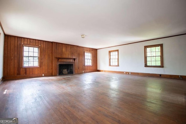 315 Dixie St, Carrollton, GA 30117 - unfurnished living room featuring crown molding, baseboards, a brick fireplace, and wood finished floors