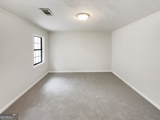 empty room with ornamental molding, carpet flooring, and a textured ceiling