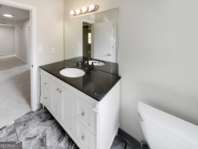 bathroom featuring tile flooring, toilet, and large vanity