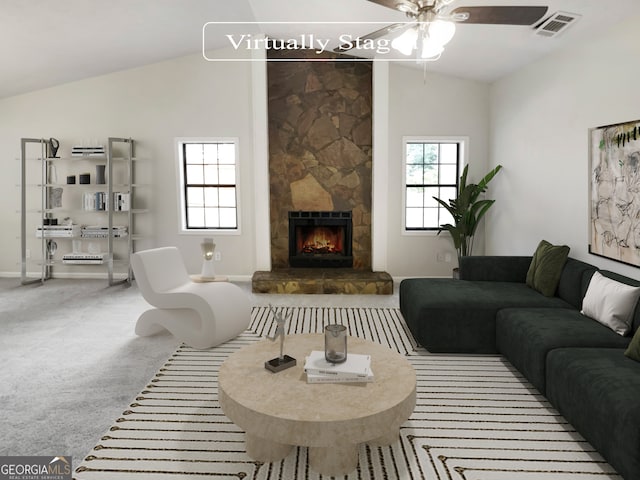 living room with light colored carpet, high vaulted ceiling, ceiling fan, and a stone fireplace