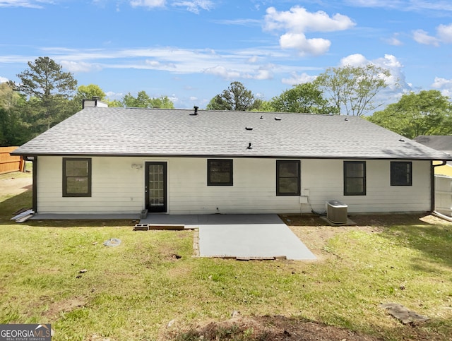 back of property featuring central AC unit, a lawn, and a patio