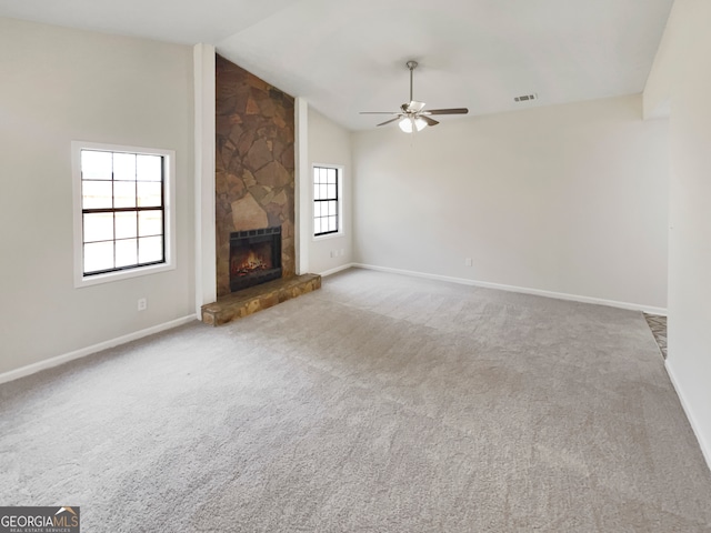 unfurnished living room featuring a healthy amount of sunlight, a fireplace, and carpet