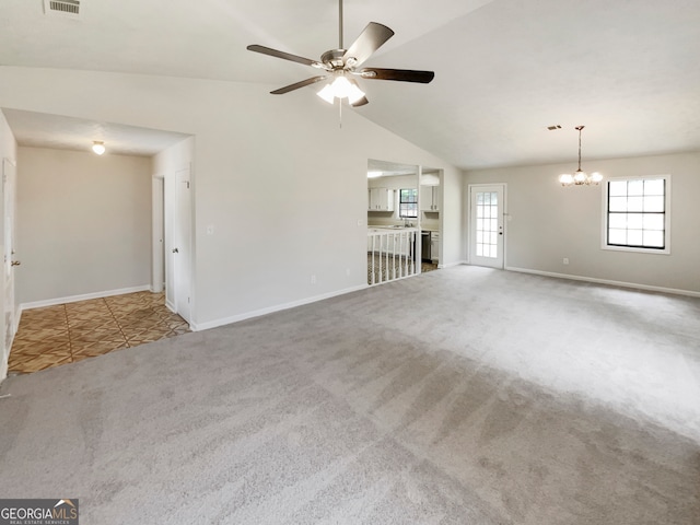 unfurnished living room featuring ceiling fan with notable chandelier, carpet flooring, and high vaulted ceiling