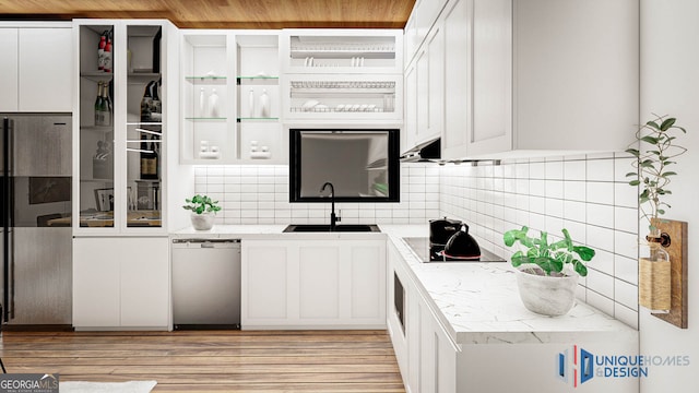 kitchen featuring dishwasher, backsplash, and white cabinetry