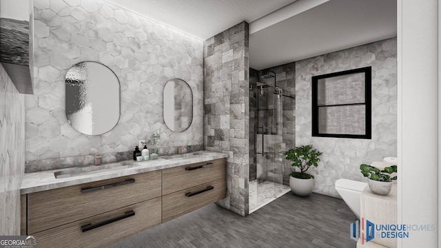 bathroom featuring tiled shower, tile walls, toilet, vanity, and hardwood / wood-style flooring