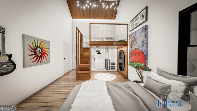 bedroom with hardwood / wood-style flooring and a high ceiling