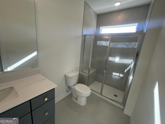 bathroom with tile patterned flooring, vanity, toilet, and a shower with door