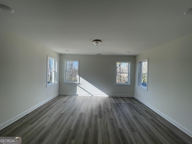 unfurnished room featuring dark wood-type flooring