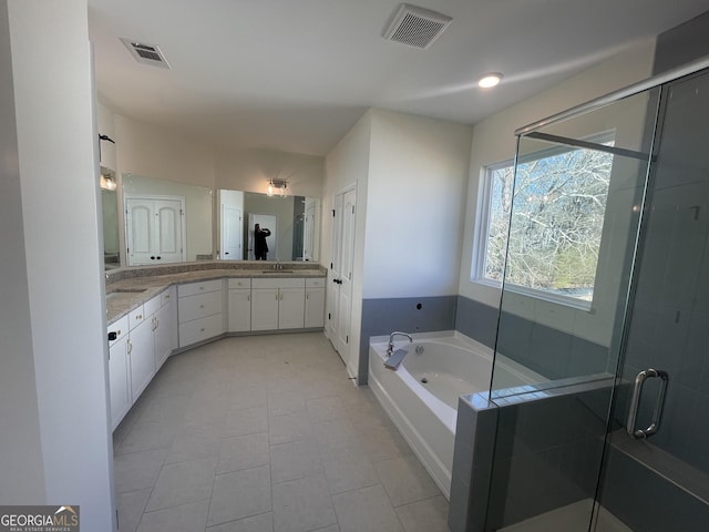 bathroom with tile patterned floors, vanity, and plus walk in shower