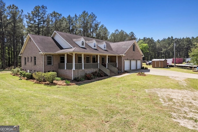 view of front facade featuring covered porch, a garage, and a front yard