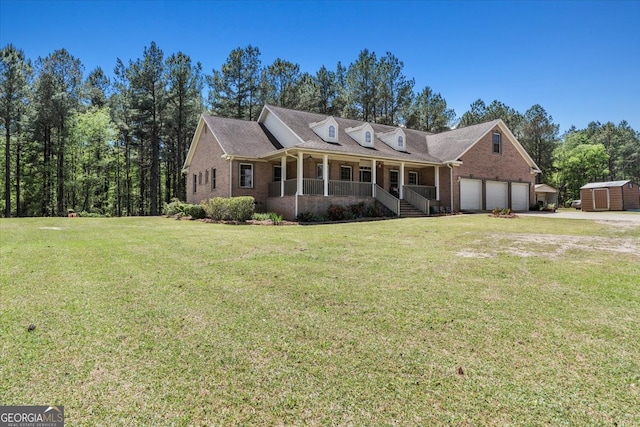 cape cod home with a garage, covered porch, a storage shed, and a front yard