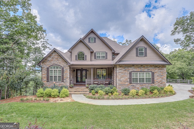 craftsman house with a front lawn and a porch