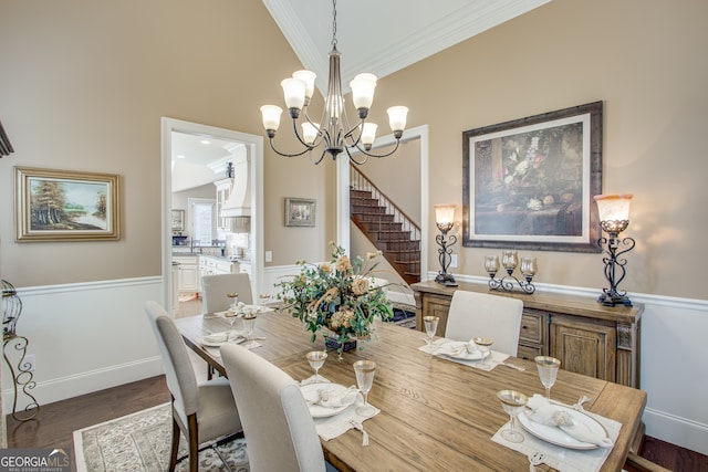 dining room with dark hardwood / wood-style flooring, crown molding, and a chandelier