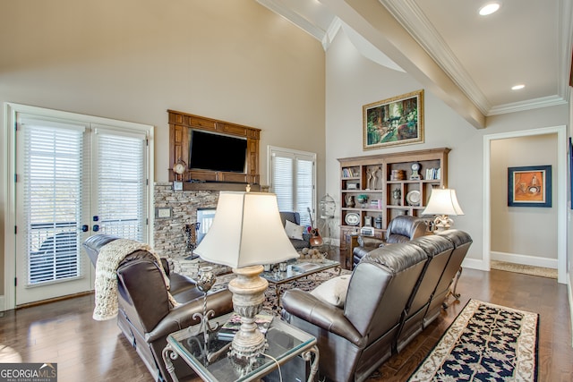 living room featuring ornamental molding, a healthy amount of sunlight, and dark wood-type flooring