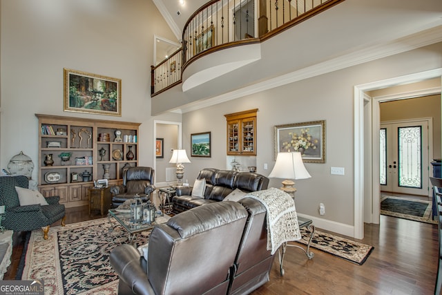 living room featuring high vaulted ceiling, ornamental molding, and hardwood / wood-style flooring