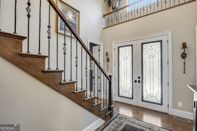 entrance foyer featuring hardwood / wood-style floors and french doors