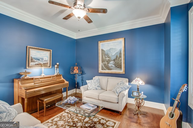 living room featuring hardwood / wood-style floors, ceiling fan, and ornamental molding