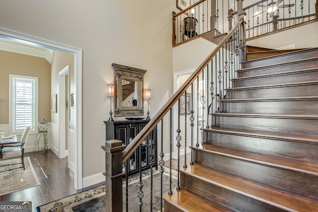 stairway featuring hardwood / wood-style floors and ornamental molding