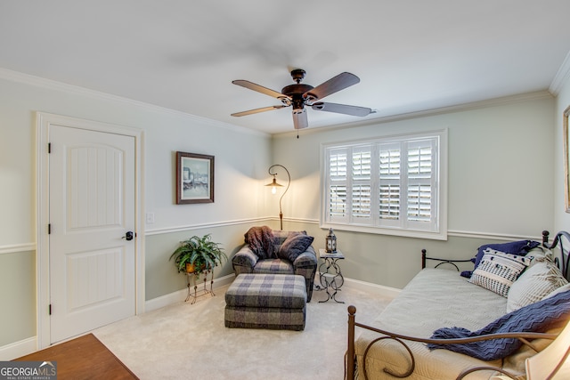 sitting room featuring ceiling fan, crown molding, and carpet flooring