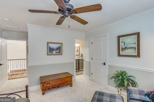 living area featuring light carpet, sink, ceiling fan, and ornamental molding