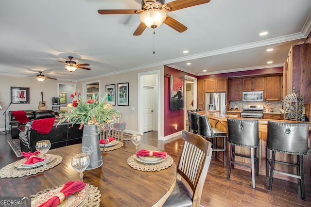 dining room featuring hardwood / wood-style floors, ceiling fan, and crown molding