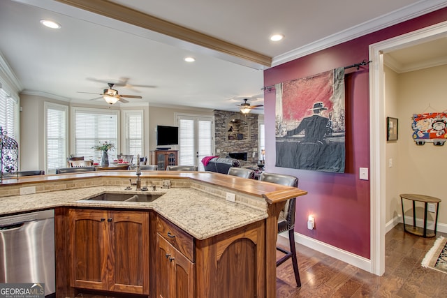 kitchen with dark hardwood / wood-style floors, sink, ceiling fan, and stainless steel dishwasher